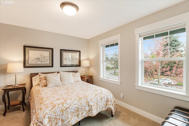 carpeted bedroom featuring baseboards