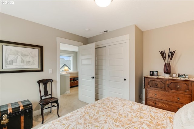 carpeted bedroom featuring visible vents, baseboards, and a closet