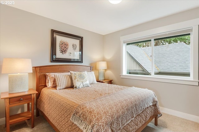 carpeted bedroom featuring baseboards