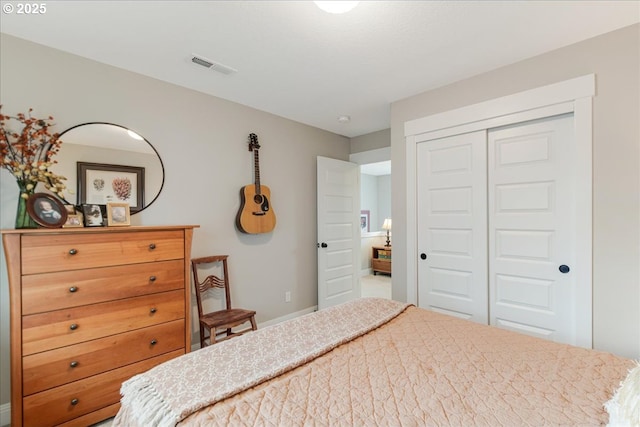 bedroom with a closet and visible vents