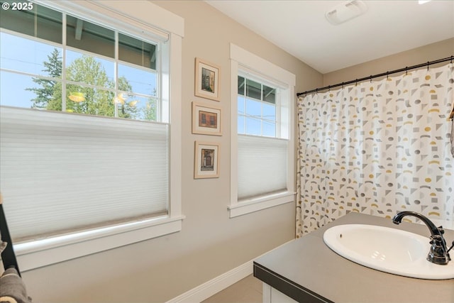 bathroom with vanity and baseboards