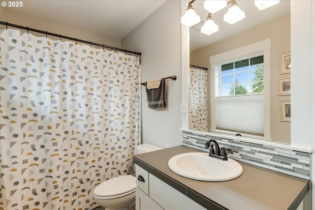 full bath featuring toilet, curtained shower, backsplash, a chandelier, and vanity