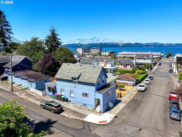 birds eye view of property featuring a water and mountain view