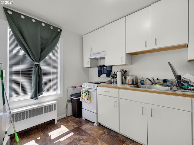 kitchen featuring sink, white electric stove, white cabinetry, and radiator