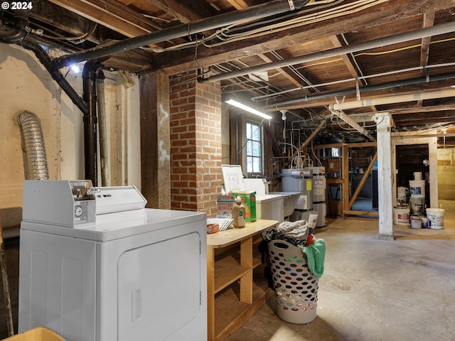 basement with washing machine and dryer, sink, and water heater