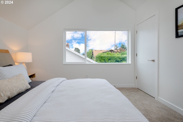 carpeted bedroom with vaulted ceiling