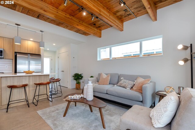 living room with beamed ceiling, wooden ceiling, and track lighting