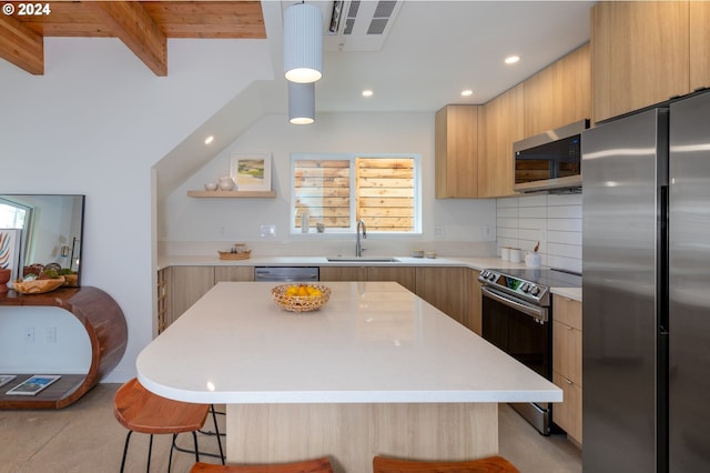 kitchen with beamed ceiling, a center island, sink, and stainless steel appliances