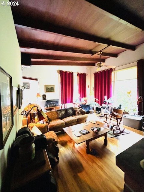 living room with hardwood / wood-style flooring, wooden ceiling, and beam ceiling