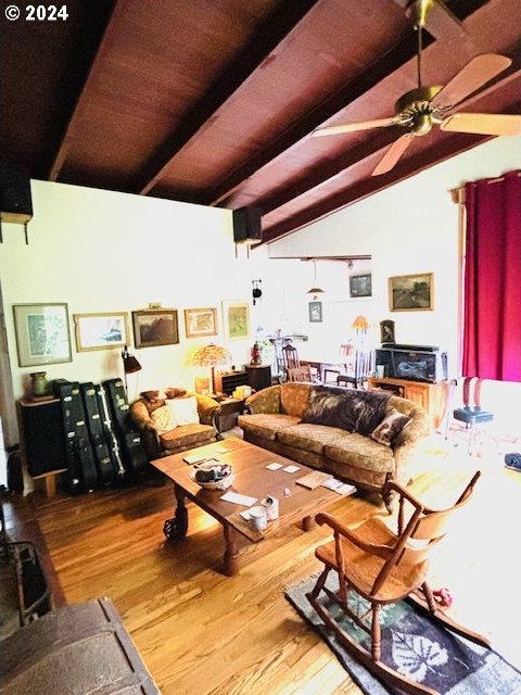 living room featuring wooden ceiling, hardwood / wood-style flooring, vaulted ceiling with beams, and ceiling fan