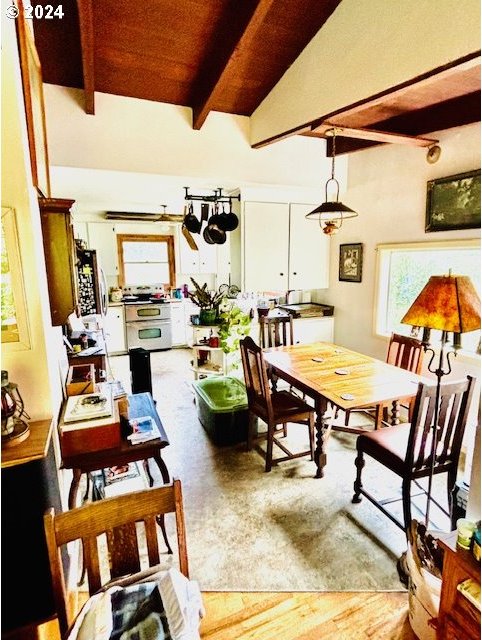 dining area featuring beam ceiling