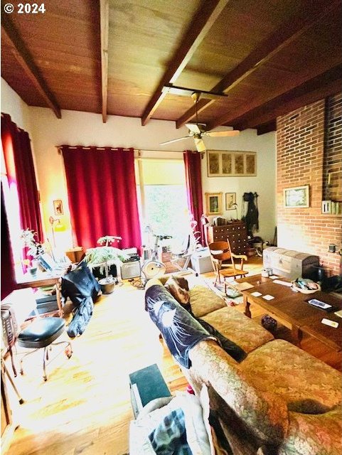 interior space featuring ceiling fan, wooden ceiling, hardwood / wood-style flooring, and beamed ceiling