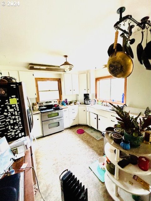 kitchen featuring a healthy amount of sunlight, white cabinetry, and stainless steel appliances