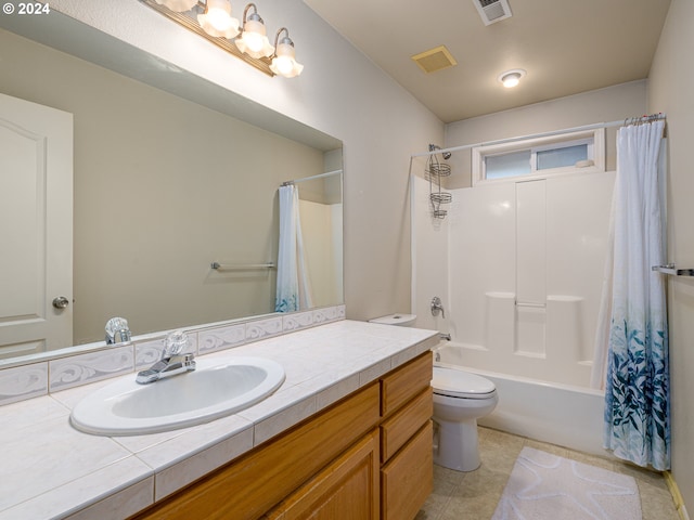 full bathroom with tile patterned floors, vanity, toilet, and shower / bath combo with shower curtain