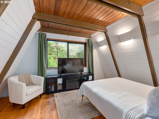 bedroom featuring hardwood / wood-style flooring, beam ceiling, and wooden ceiling