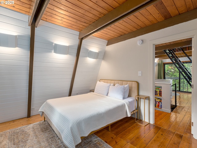 bedroom with wooden ceiling, beamed ceiling, and light hardwood / wood-style floors