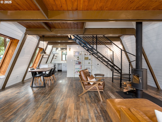 living room featuring wood walls, dark hardwood / wood-style flooring, and a wood stove