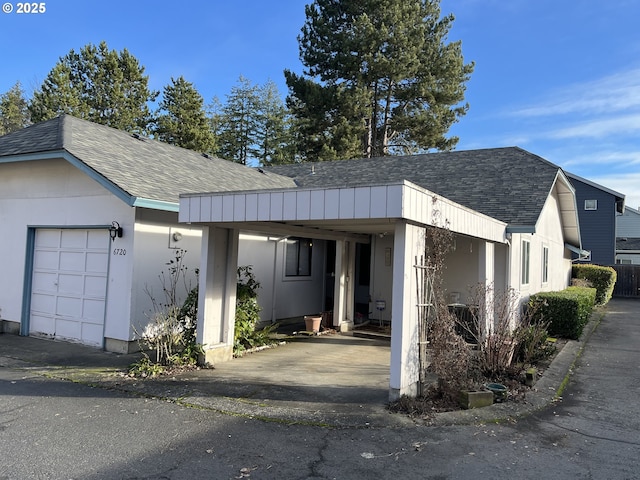 view of front of house featuring a carport and a garage