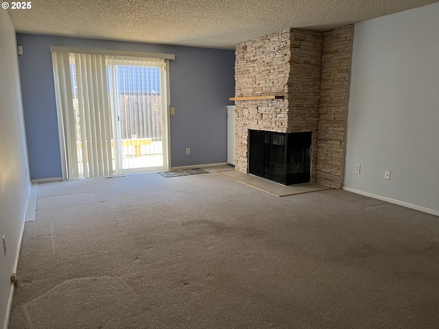 unfurnished living room featuring light colored carpet, a textured ceiling, and a stone fireplace