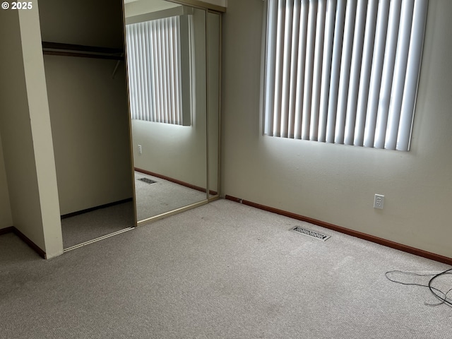 unfurnished bedroom with carpet floors and a closet