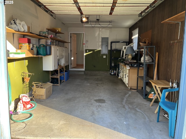 garage with a garage door opener and electric panel