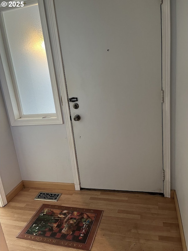 doorway with light wood-type flooring