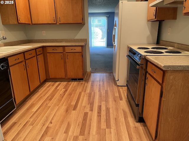 kitchen featuring light hardwood / wood-style flooring, electric stove, sink, black dishwasher, and a textured ceiling