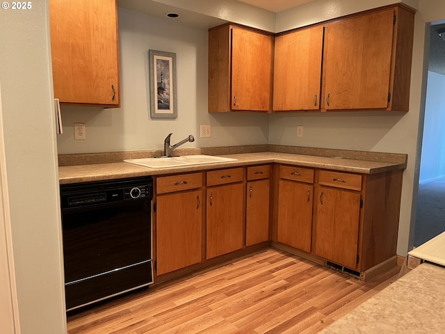 kitchen featuring light hardwood / wood-style flooring, sink, and black dishwasher