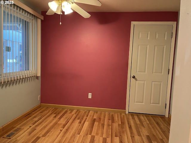 unfurnished room with ceiling fan and light wood-type flooring