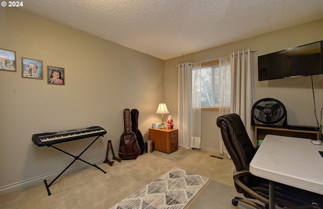 office area featuring light colored carpet and a textured ceiling