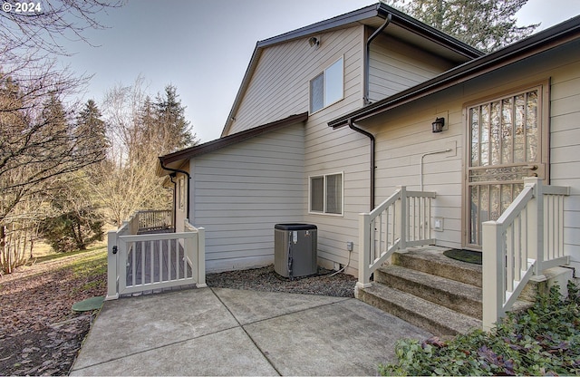 back of house featuring central air condition unit