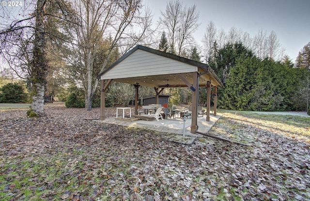 view of yard featuring a gazebo, ceiling fan, and a patio area