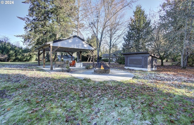 view of yard featuring a patio and a fire pit