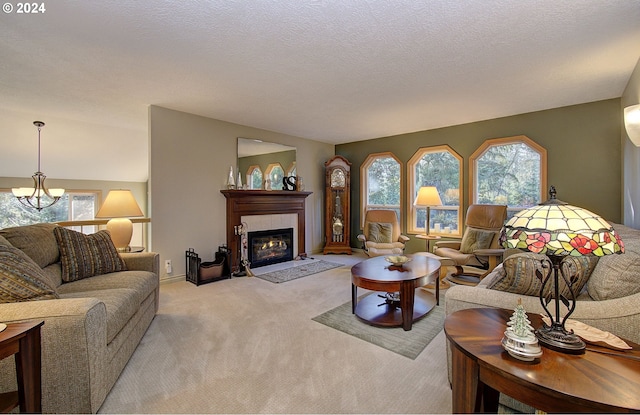 living room with a tiled fireplace, light carpet, and a textured ceiling