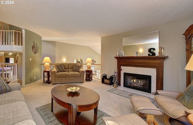 living room featuring a tile fireplace, light carpet, a textured ceiling, and lofted ceiling