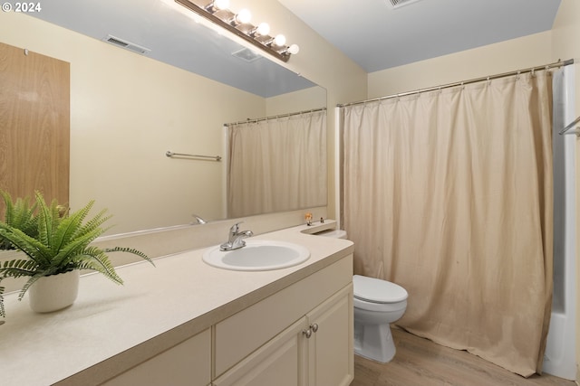 bathroom featuring vanity, toilet, and hardwood / wood-style flooring