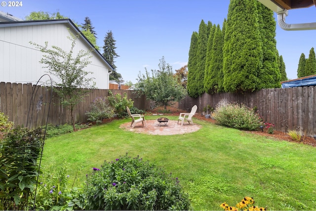 view of yard with a fire pit