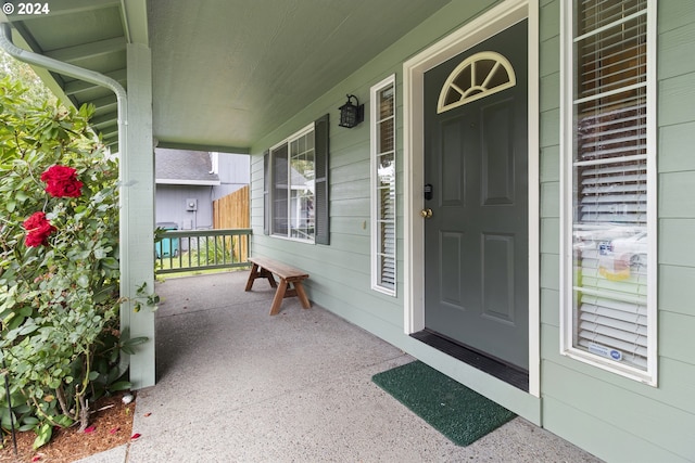 view of exterior entry with covered porch