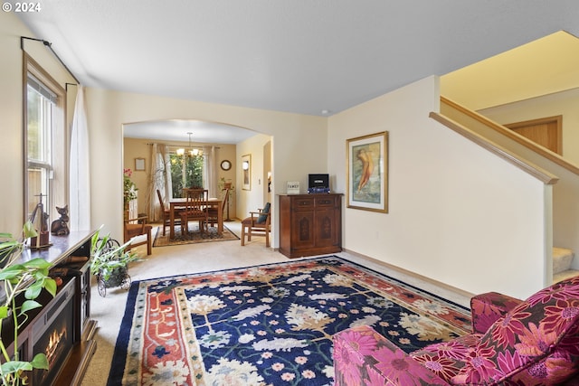 carpeted living room featuring a chandelier and a wealth of natural light