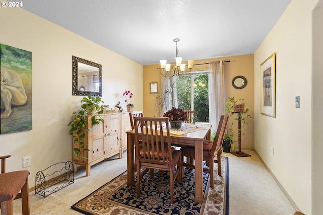 dining space with light colored carpet and a notable chandelier