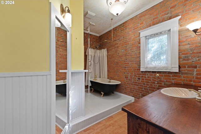 bathroom with brick wall, crown molding, shower with separate bathtub, and wood-type flooring