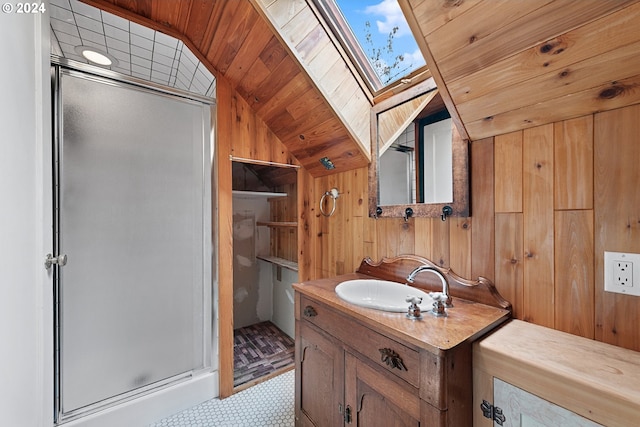 bathroom with wood ceiling, vaulted ceiling with skylight, walk in shower, vanity, and wood walls