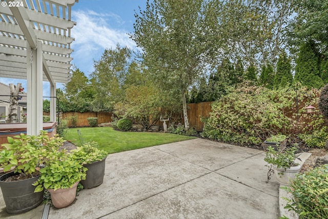 rear view of property with a lawn, a pergola, a patio, and a hot tub