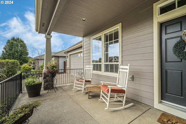 view of patio / terrace with a garage and covered porch