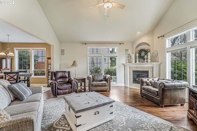 living room with high vaulted ceiling, a chandelier, and light hardwood / wood-style floors