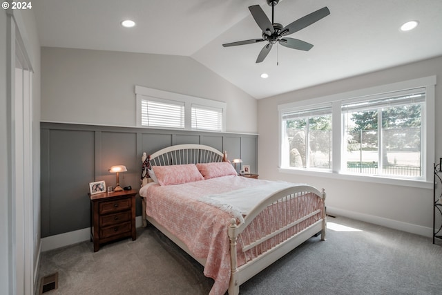 carpeted bedroom with ceiling fan, lofted ceiling, and multiple windows