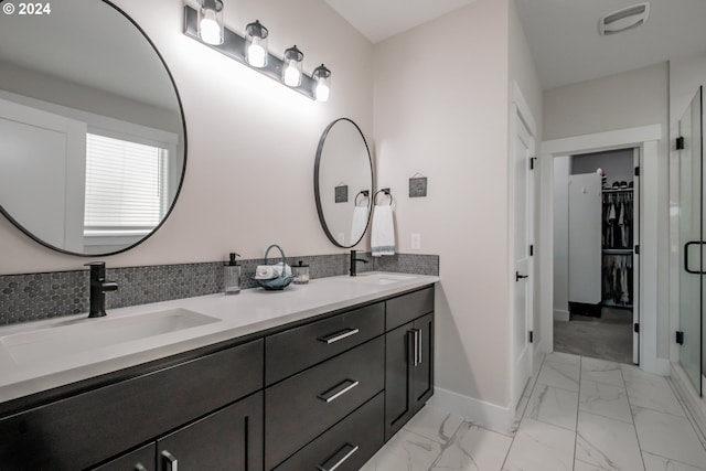 bathroom with tasteful backsplash and vanity