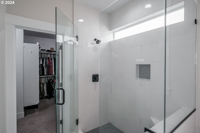 bathroom with a shower with door