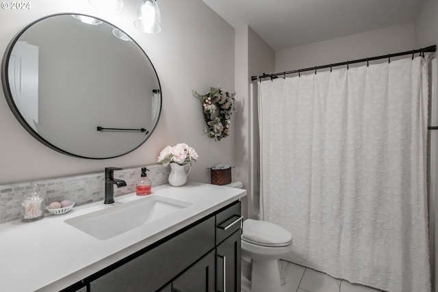 bathroom with vanity, backsplash, and toilet