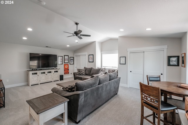 carpeted living room with lofted ceiling and ceiling fan